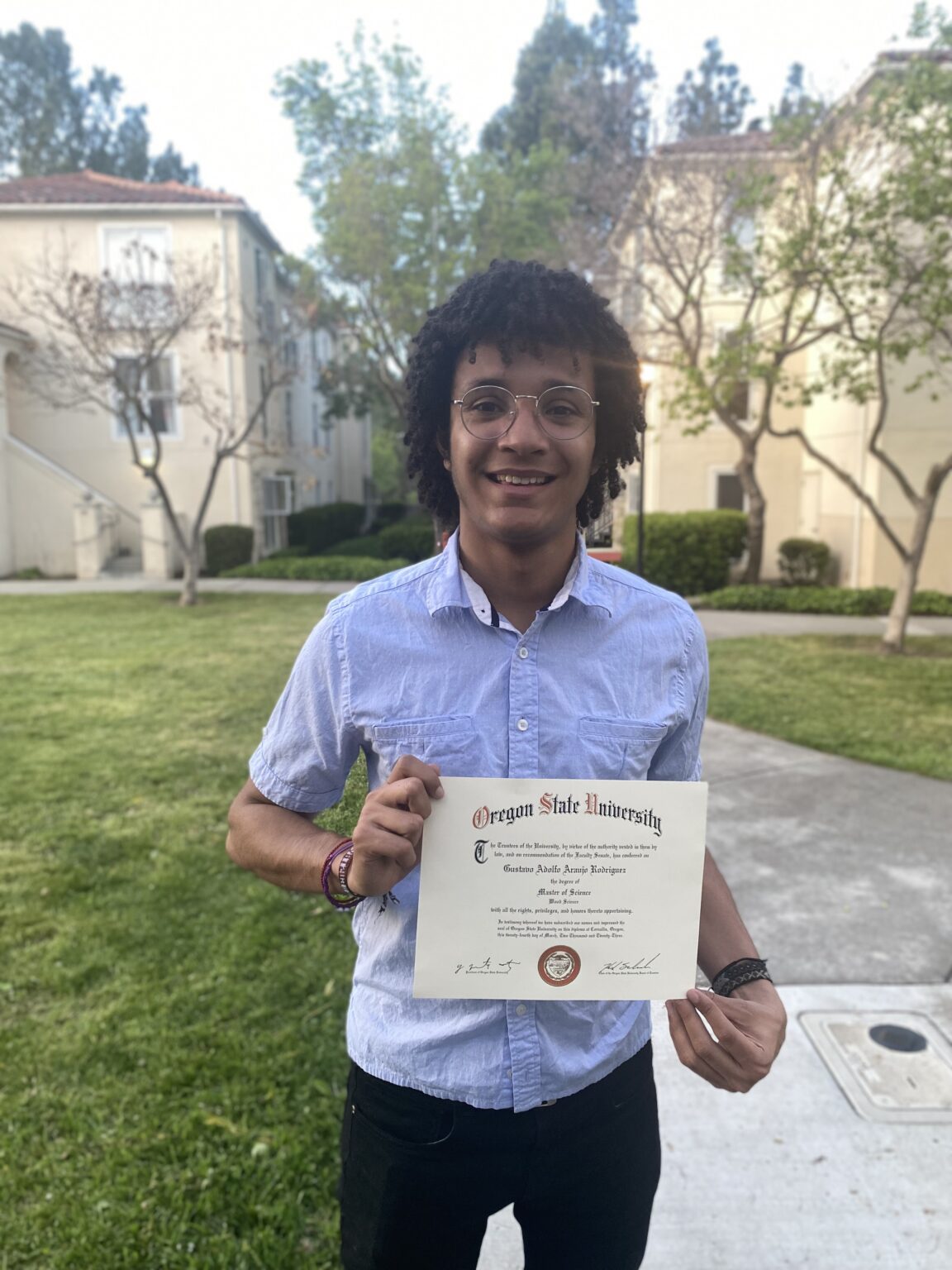 Gustavo A. Araújo R. holding his Oregon State University Master of Science in Wood Science diploma